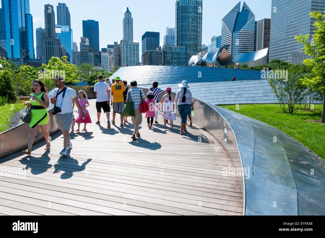 People crossing the BP Bridge in Chicago, designed by Frank Gehry. Stock Photo