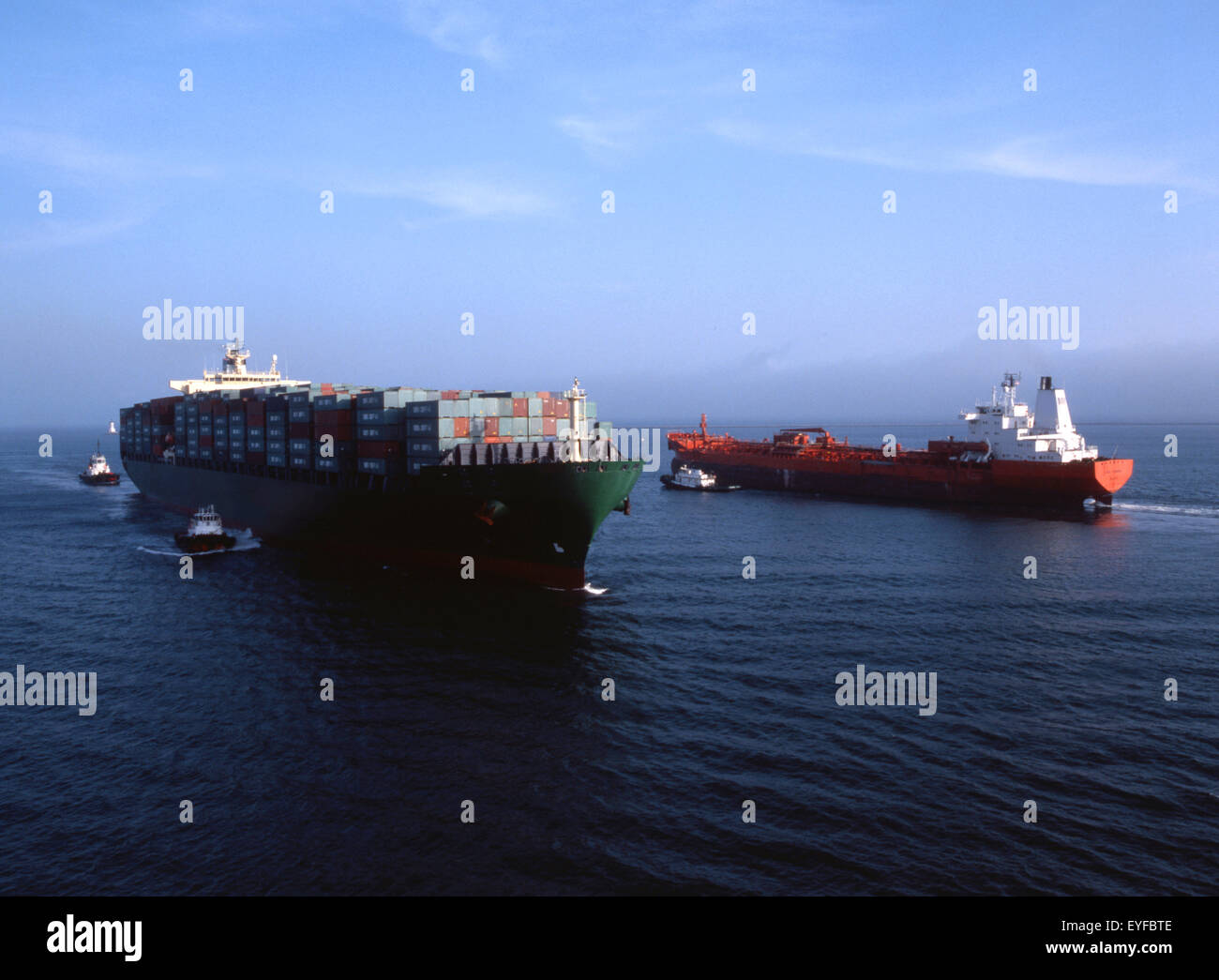 containership and freighter passing each other in the harbor Stock Photo
