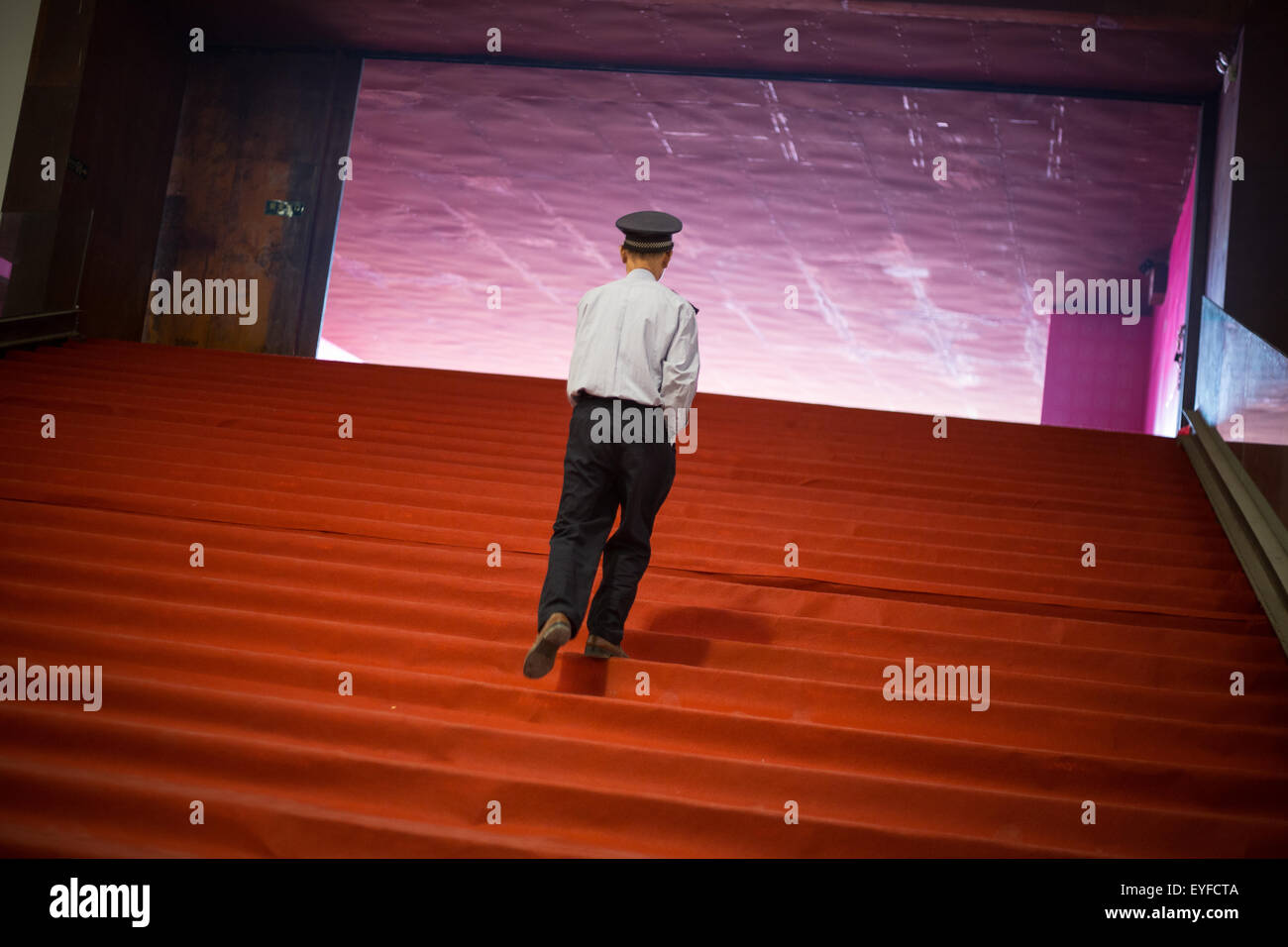Security guard ascends stairs in a gallery, Songzhuang Art District, in Beijing, China Stock Photo