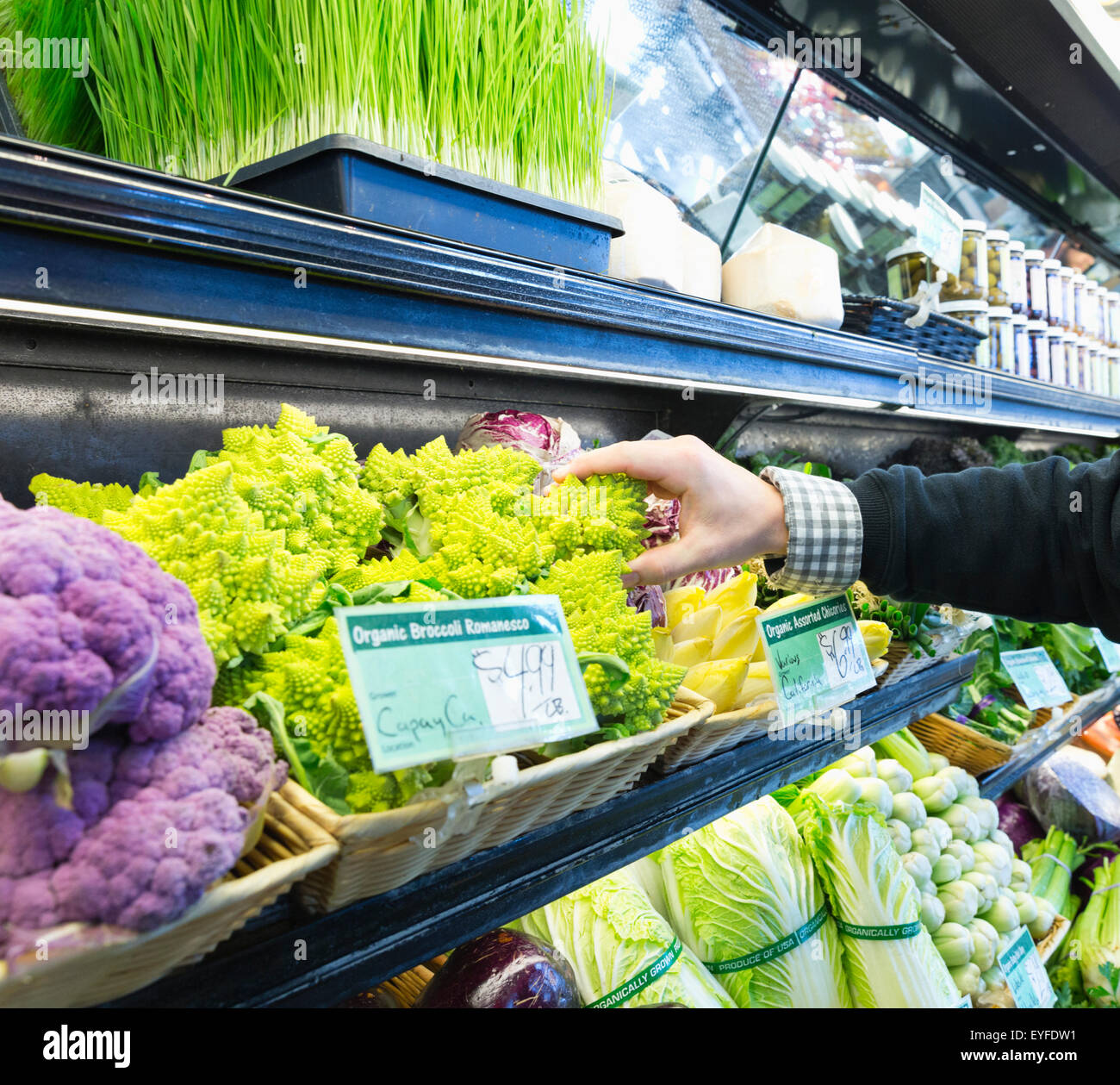 Man choosing broccoli in supermarket Stock Photo