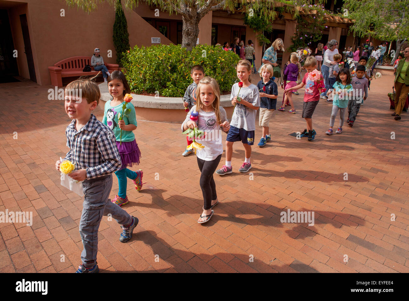 Multiethnic children bring bouquets to the Crowning of Mary at a Laguna ...