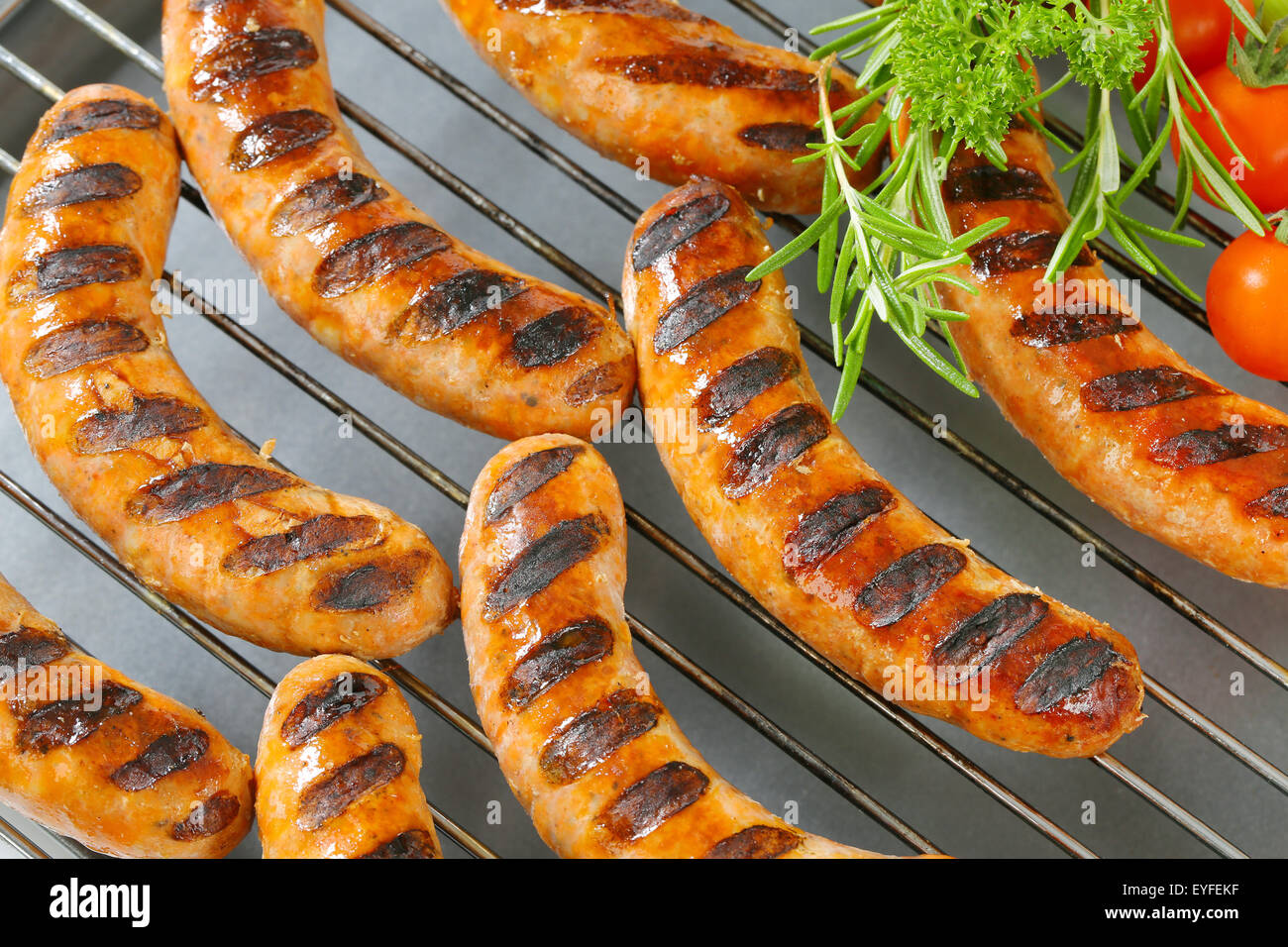 Grilled bratwursts on barbecue grid Stock Photo