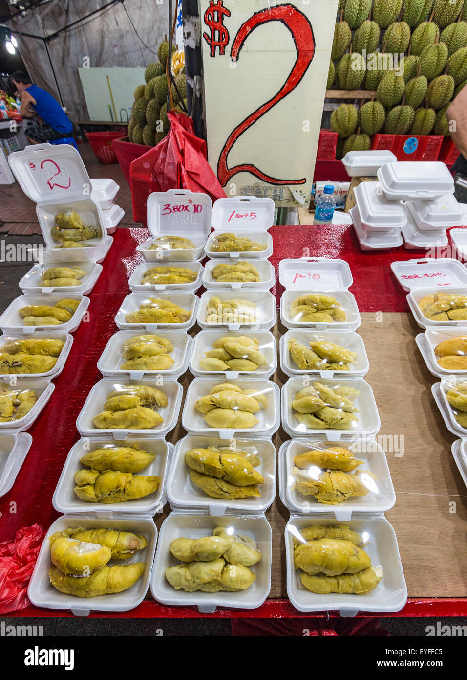 Famously smelly durian fruit, for sale at a night market in Singapore. The sickly sweet smell from this fruit is so intense, it Stock Photo