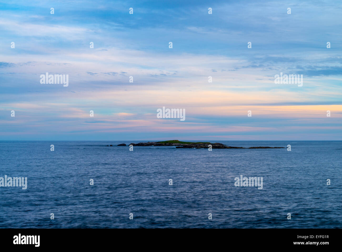 A small island in Atlantic Ocean viewed at sunset from Louisbourg lighthouse, Louisbourg, Nova Scotia, Canada - Stock Image