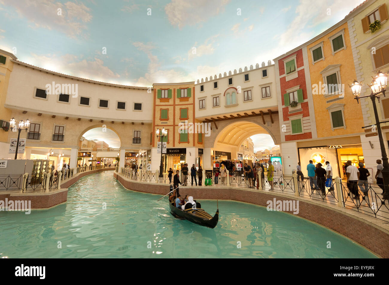 Electric gondola on canal in the Villagio shopping mall; Doha, Qatar Stock Photo