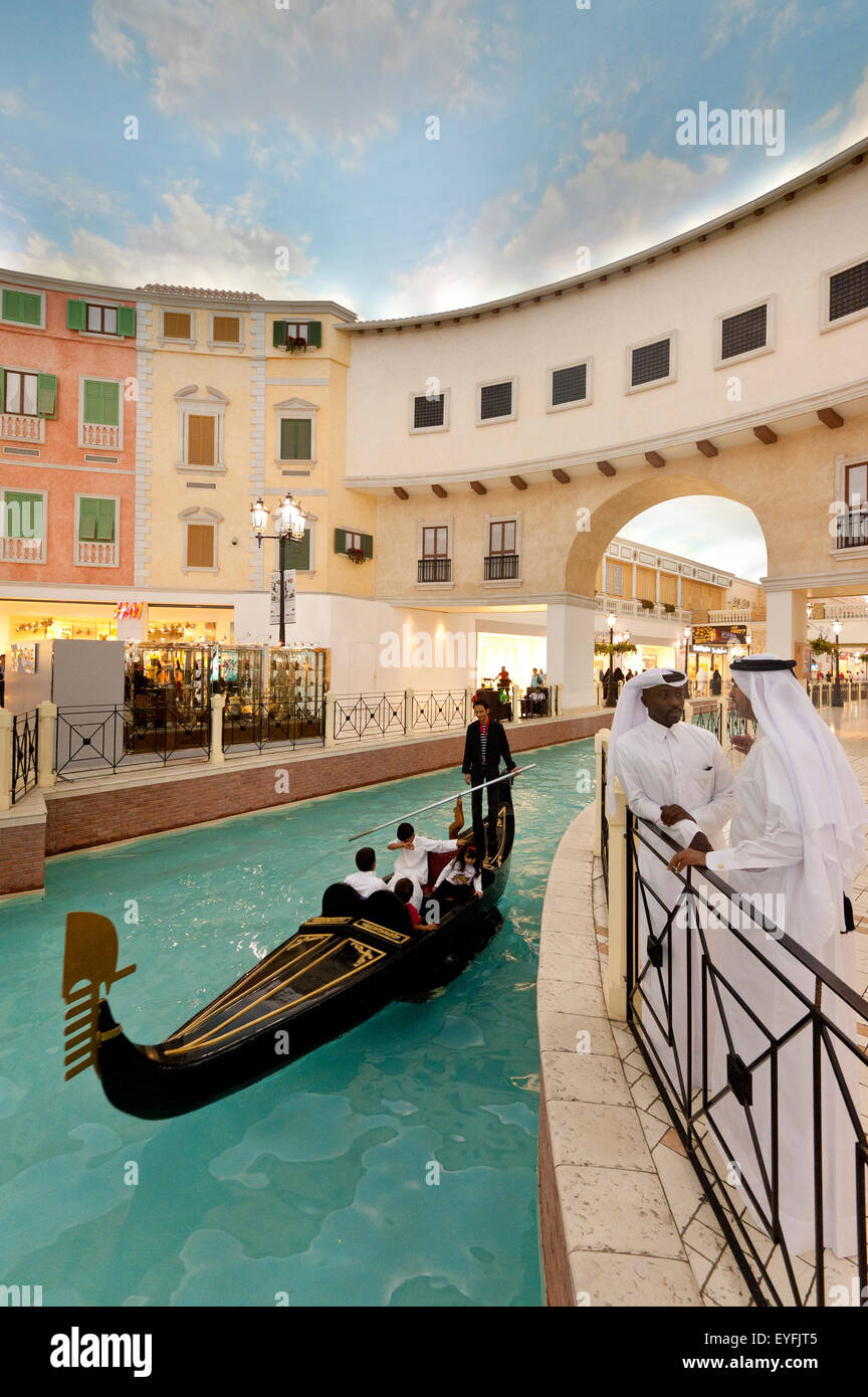 Electric gondola on canal in the Villagio shopping mall; Doha, Qatar Stock Photo