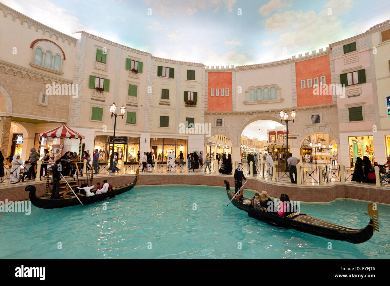 Electric gondolas on canal in the Villagio shopping mall; Doha, Qatar Stock Photo