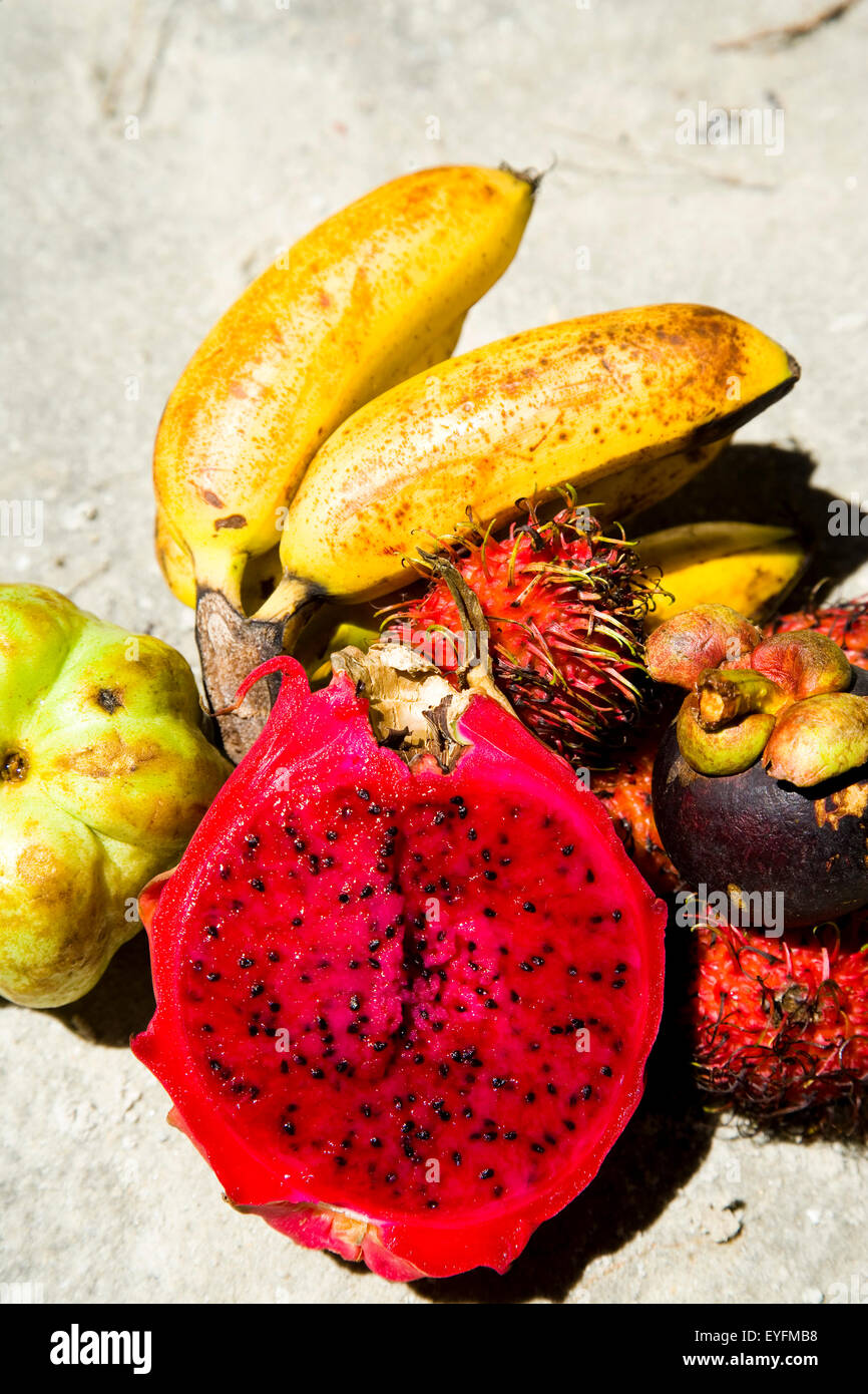 Fruit selection of dragon fruit, seedless guava, mangostine and rambutan on Cenang beach; Pulau Langkawi, Malaysia Stock Photo