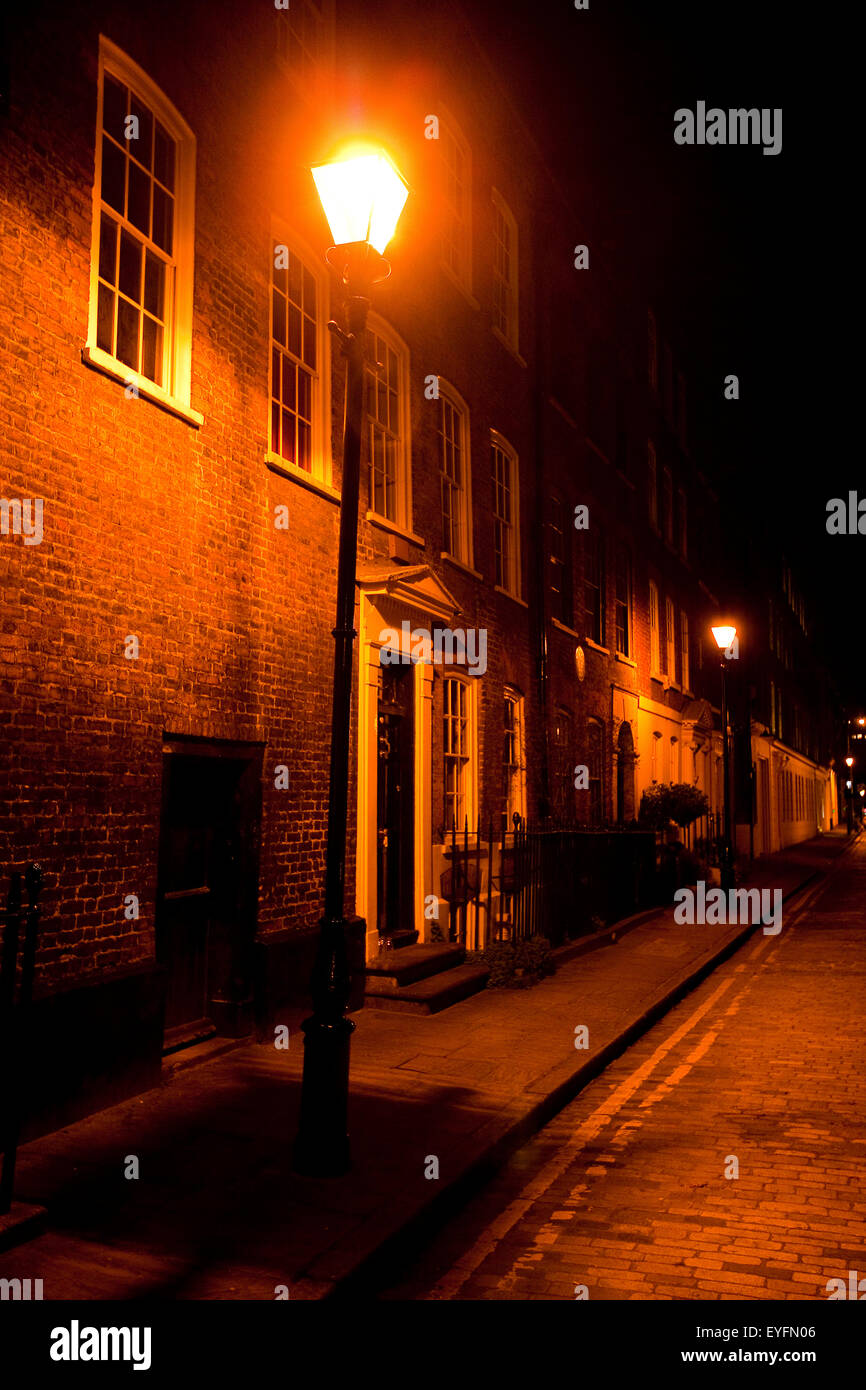 Victorian street lamp lights streets of East London at night; London