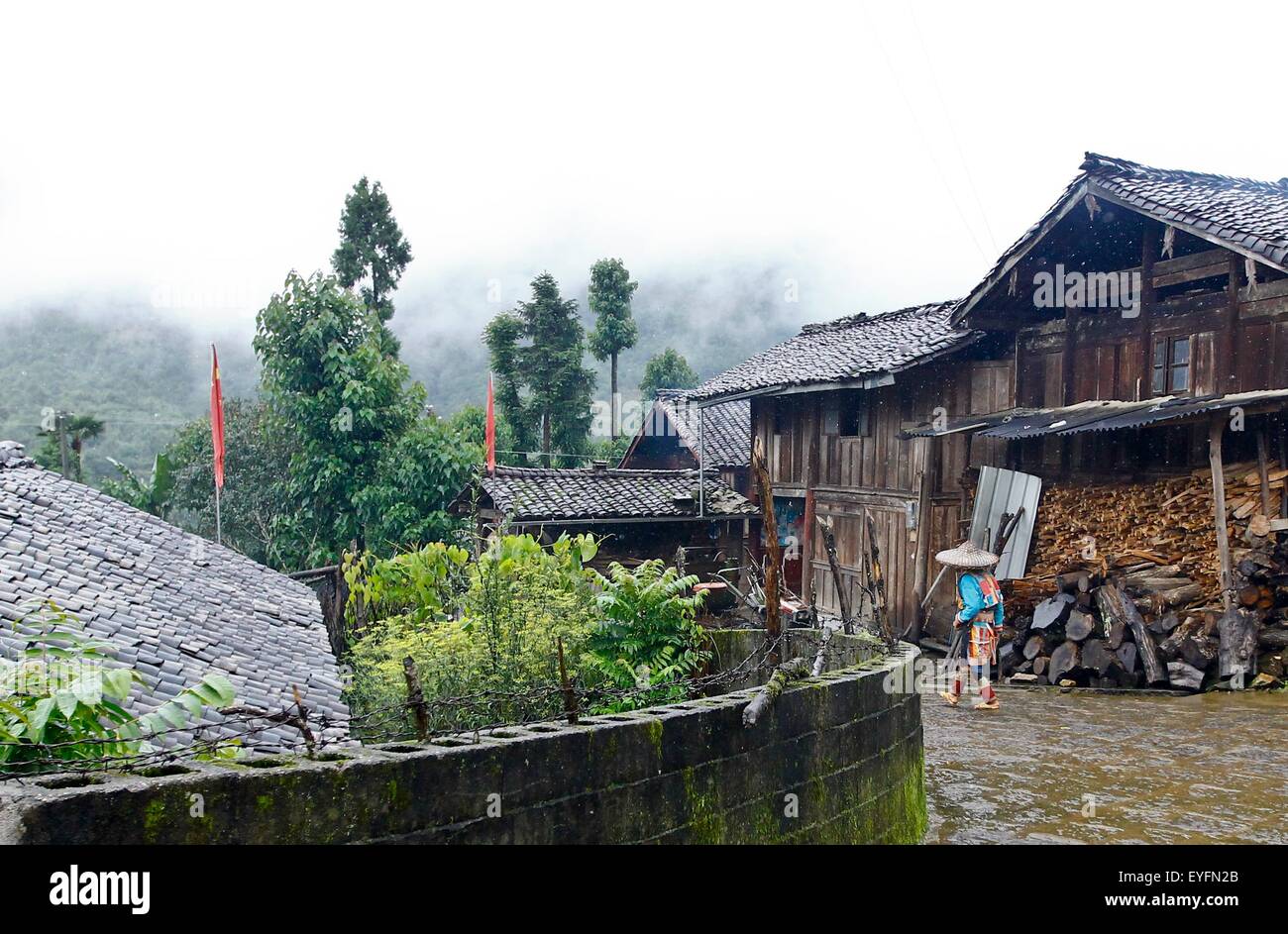 Beijing, China's Yunnan Province. 23rd July, 2015. A villager of Lisu ethnic group walks on a path in Caijiazhai Village of Houqiao Township, Tengchong, southwest China's Yunnan Province, July 23, 2015. Houqiao Township is located in a gateway of the Stilwell Road linking southwest China's Yunnan and Myanmar, also known as the Burma Road, on which guns, ammunition, food and other badly needed materials were carried by U.S. trucks to China to fight against the Japanese troops. © Lin Yiguang/Xinhua/Alamy Live News Stock Photo