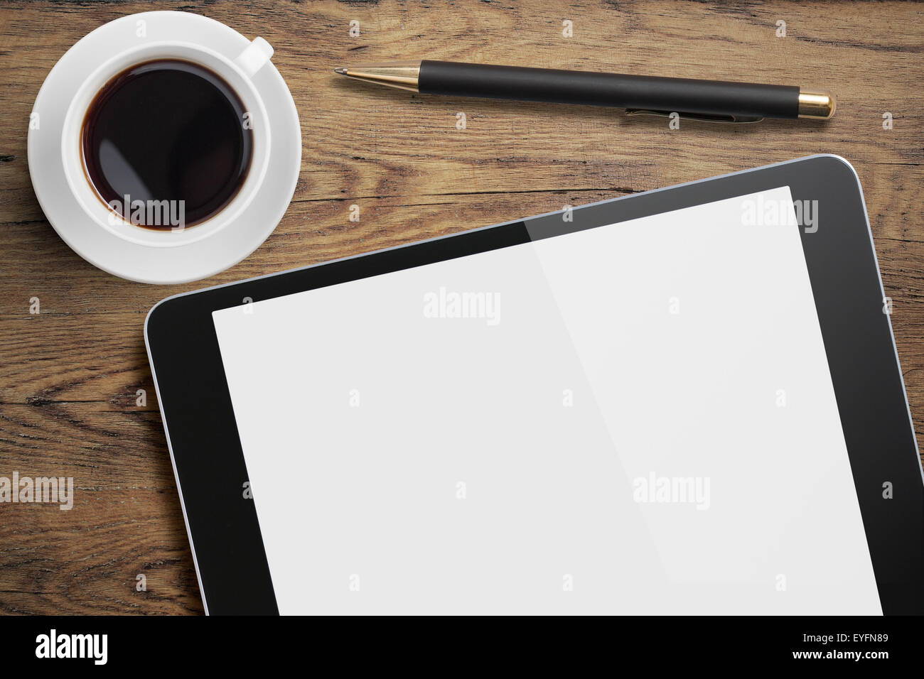 Tablet pc on table desk with coffee cup and pen Stock Photo