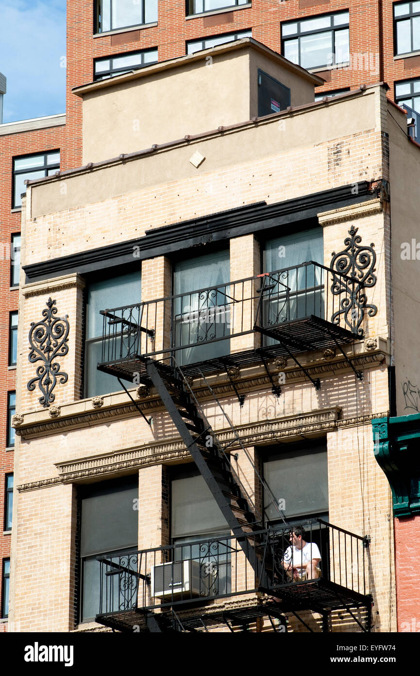 Man Sitting Outside A Traditional Apartments Building In Tribeca