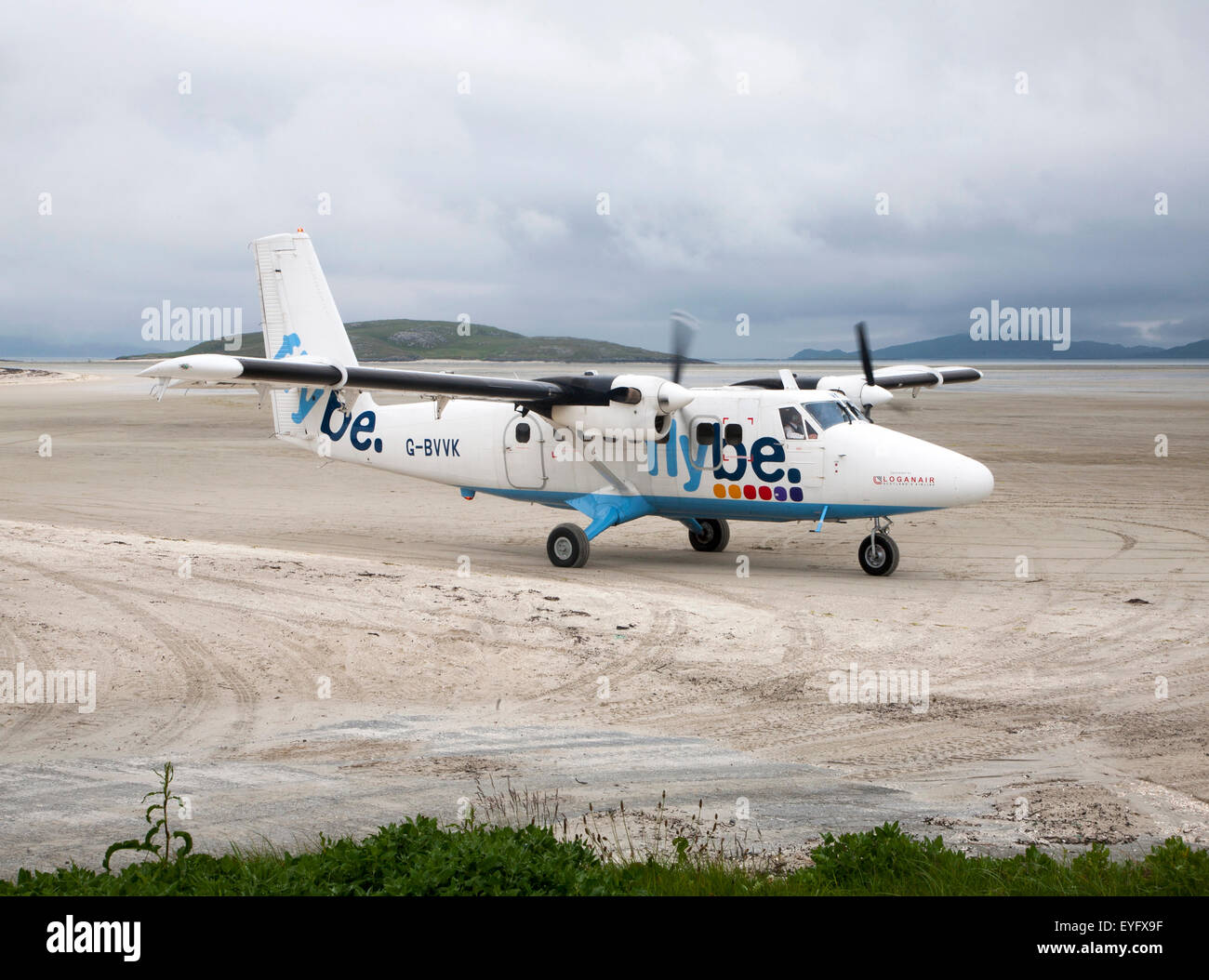 Flybe plane on sandy airstrip Isle of Barra airport , Barra, Outer Hebrides, Scotland, UK Stock Photo