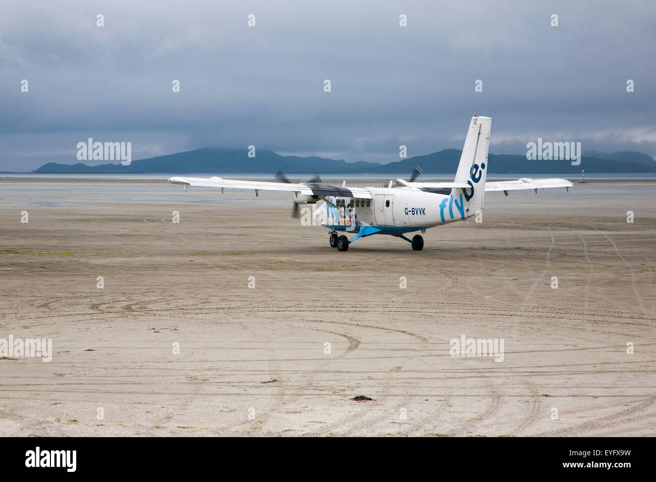 Flybe plane on sandy airstrip Isle of Barra airport, Barra, Outer Hebrides, Scotland, UK Stock Photo