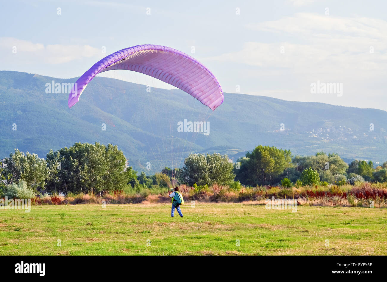 A parachute jumper training at the sports ground against the wind Stock Photo