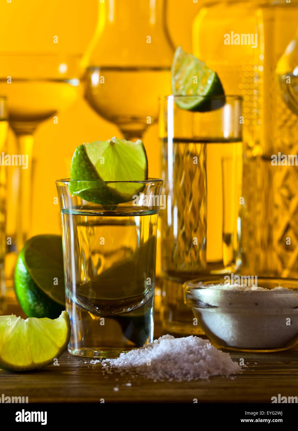 gold tequila , lime and salt on wooden table Stock Photo Alamy