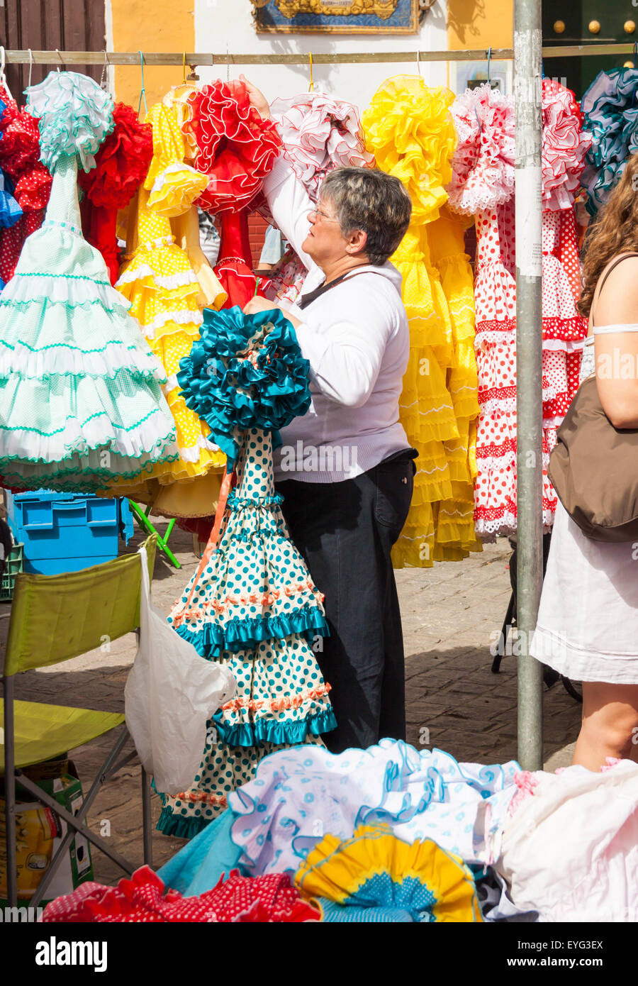 Secondhand Flamenco dresses on famous street Flea market in Calle Feria in Seville, Spain Stock Photo