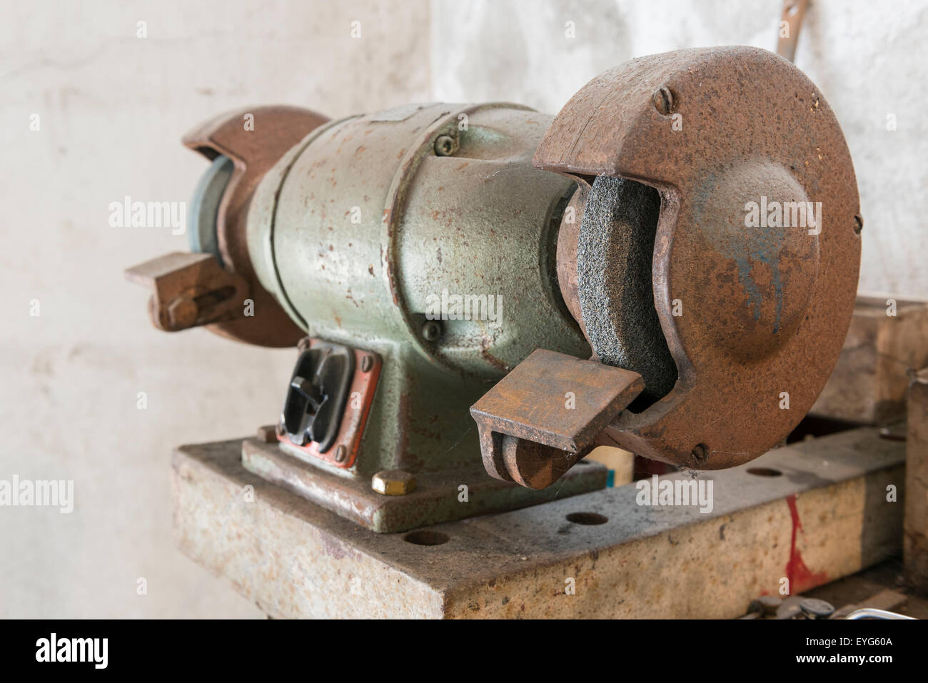 old grinder on workbench with old work tools in home garage Stock