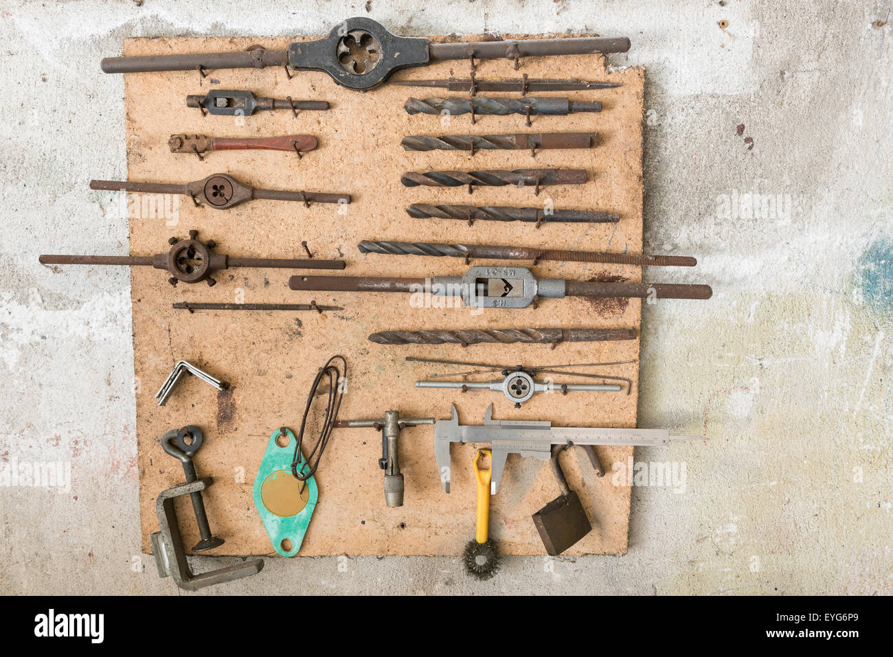 old work tools hanging in wall garage Stock Photo