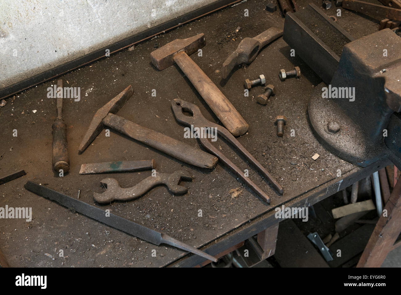 old workbench with old work tools in home garage Stock Photo