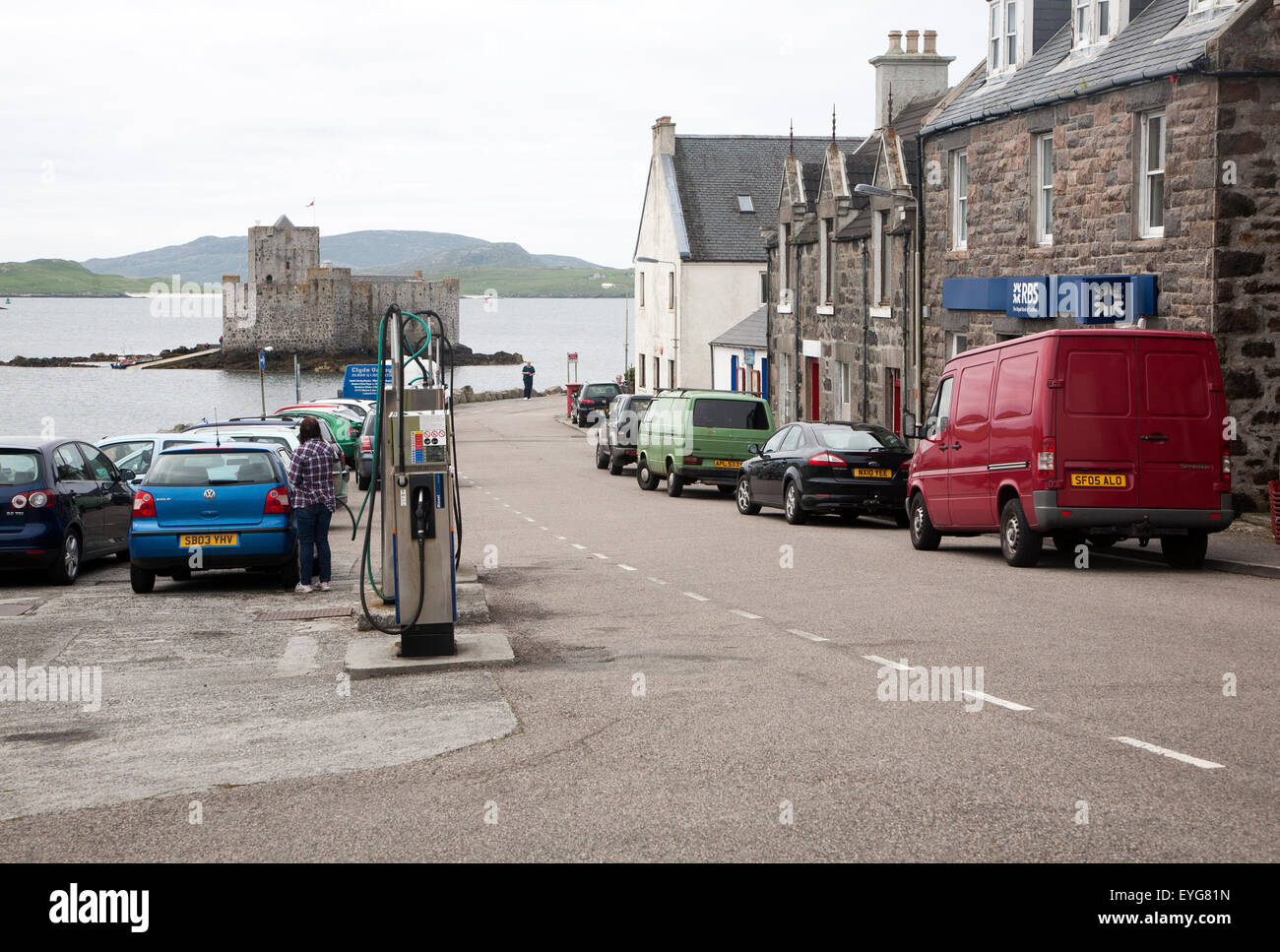 Main shopping street in Castlebay the largest settlement in Barra, Outer Hebrides, Scotland, UK looking to Kisimul castle Stock Photo