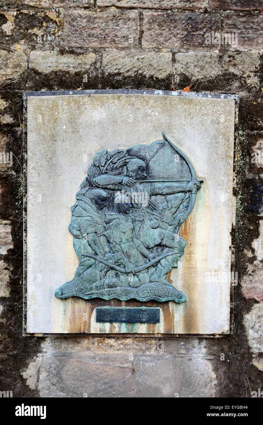 Plaque on the castle wall showing Robin Hood, Maid Marian and Friar Tuck with hounds fighting Guy of Gisbornes men, Nottingham, Stock Photo