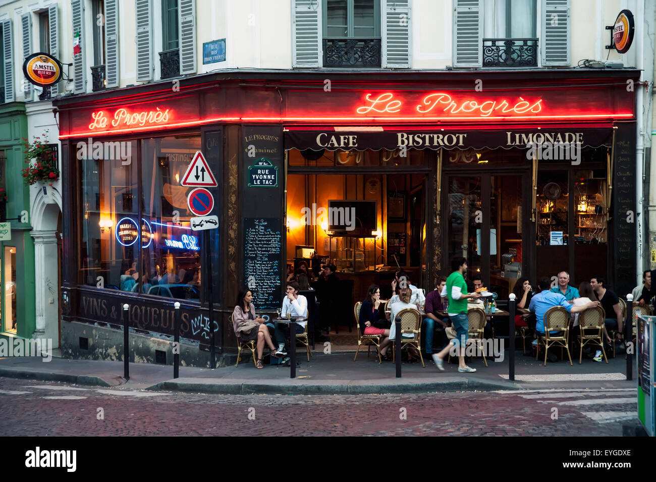 France, Montmartre; Paris, People enjoying summer evening at sidewalk cafe Stock Photo