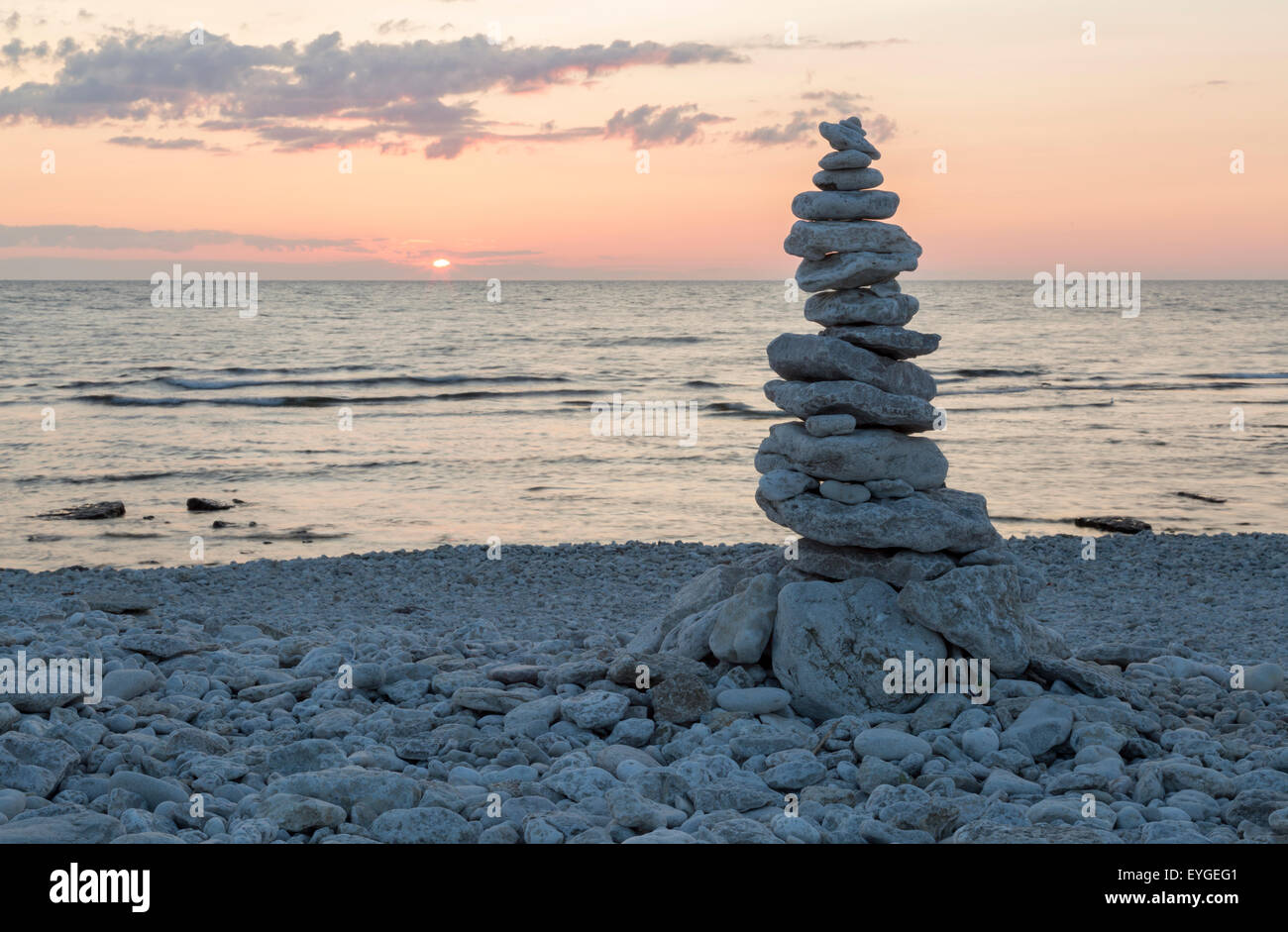 Rocks Piled on Each Other by ocean at sunset. Stock Photo