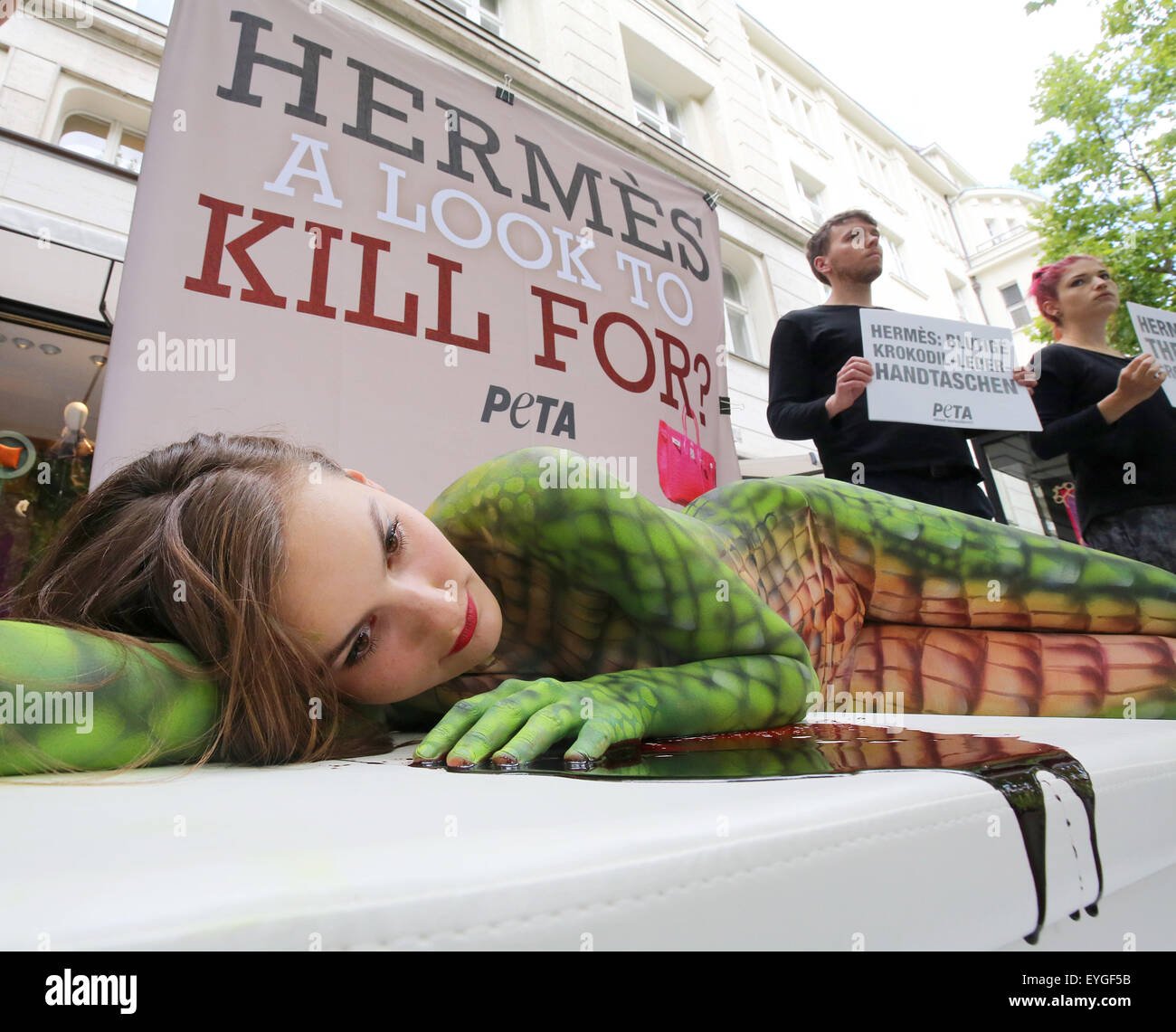 Berlin, Germany. 29th July, 2015. Members of the animal rights group Peta  protest in front of a shop of the brand Hermes against the killing of  crocodiles for luxury leather bags in