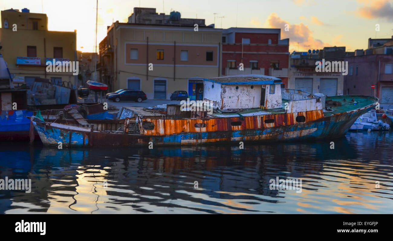A dilapidated boat in the water at Mazara del Vallo in Sicily Stock Photo