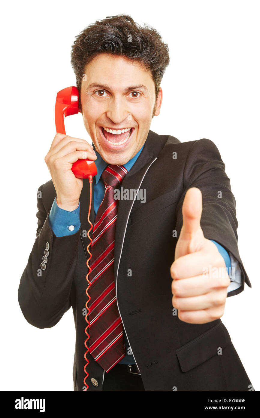 Cheering winner on the phone holding his thumb up Stock Photo