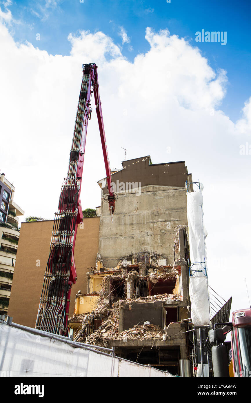 crane and digger working on building demolition in cities Stock Photo