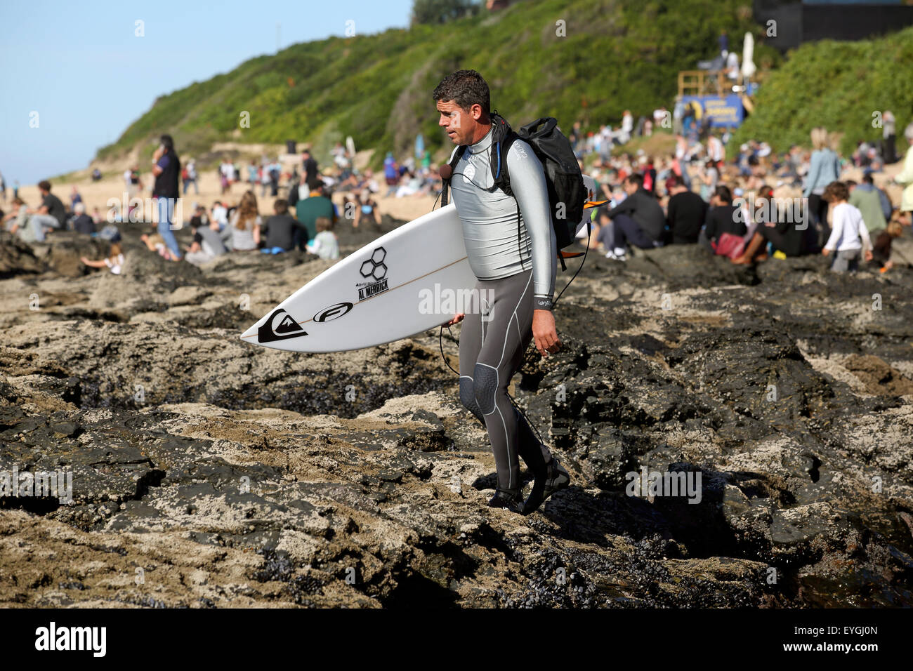 Big wave surfer and WSL commentator Peter Mel walks to the surf for water commentary at the 2015 J Bay Open Stock Photo