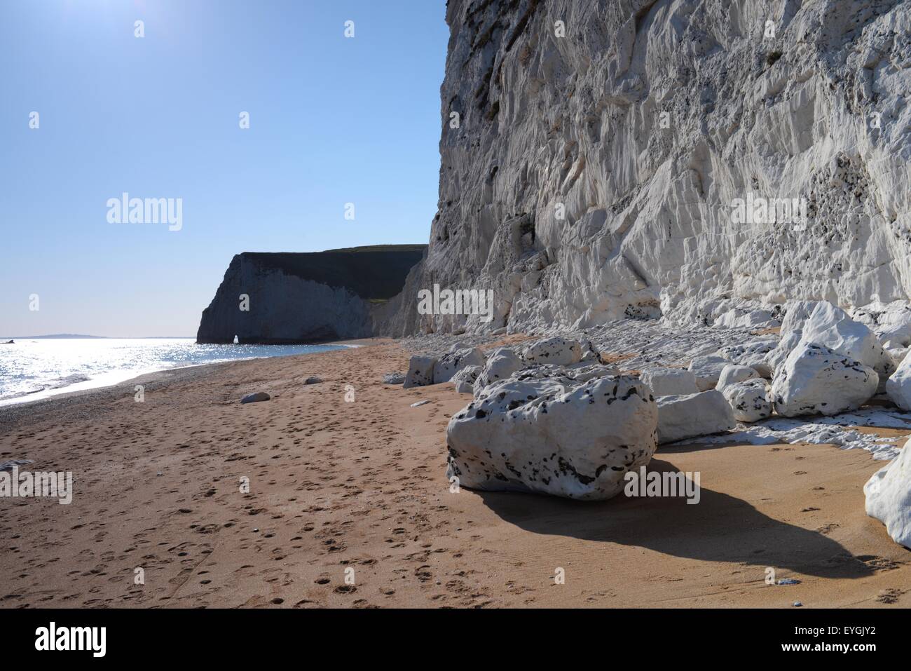 White chalk cliffs and fallen rocks on the beach at Durdle Door, West ...