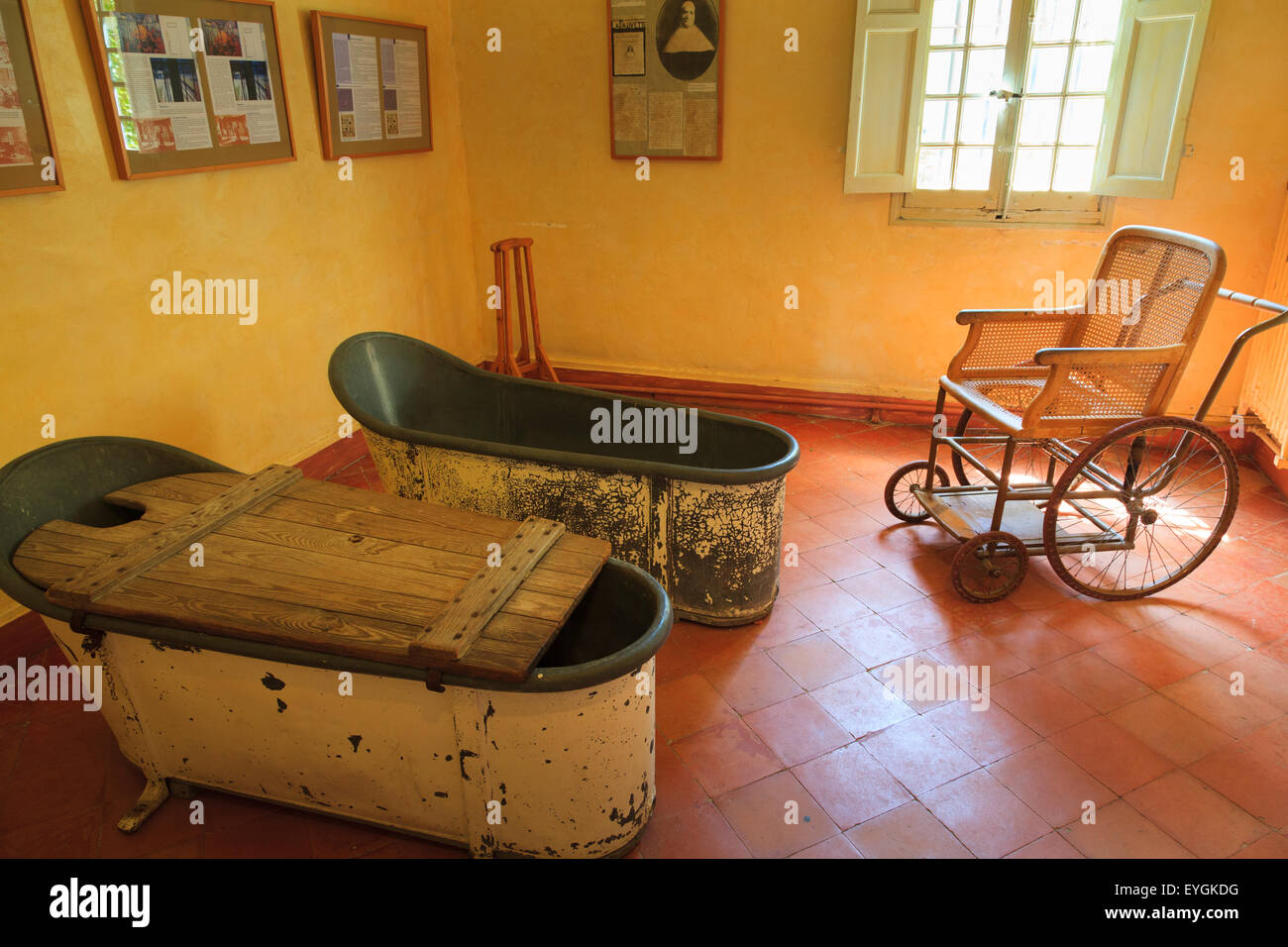 Antique freestanding baths and wheelchair in Maison de Sante Saint Paul Monastery at Saint Remy Stock Photo