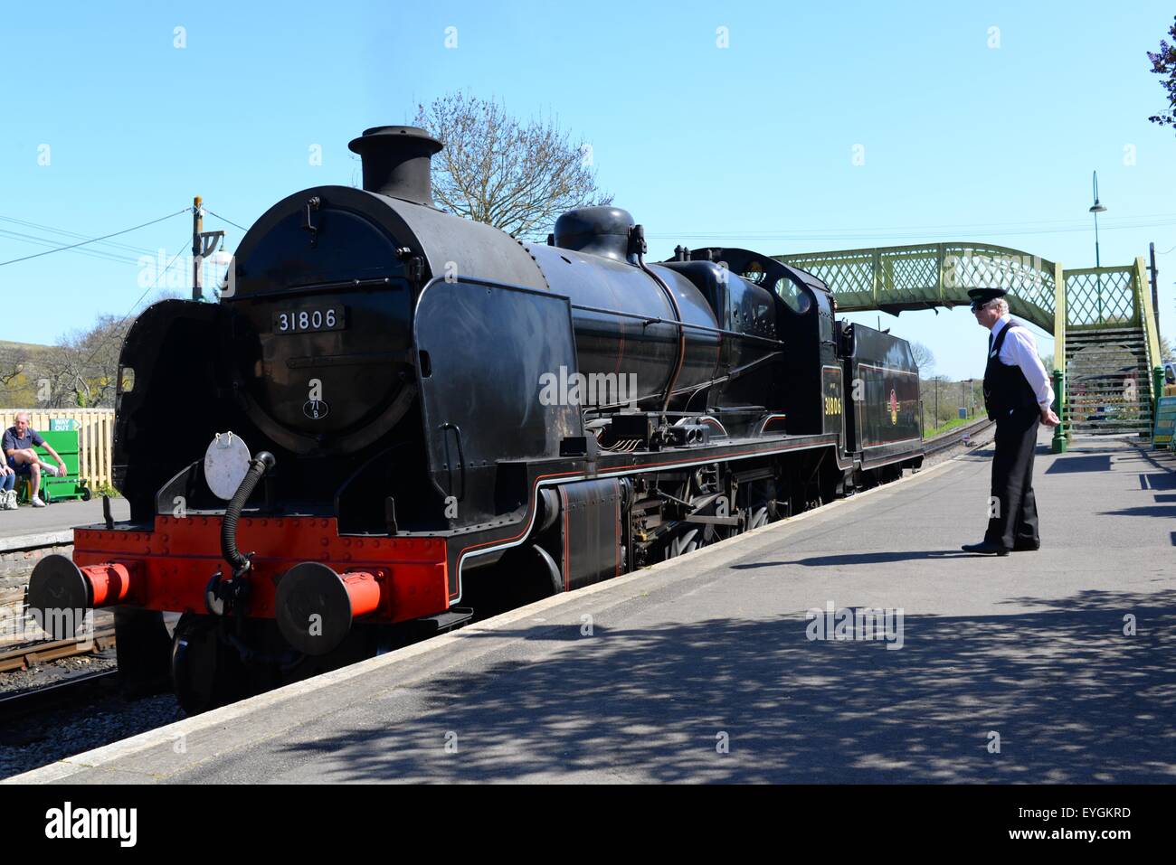 Corfe Caste station on the Swanage Heritage Railway. Stream train with station master/guard, Dorset, UK. Stock Photo