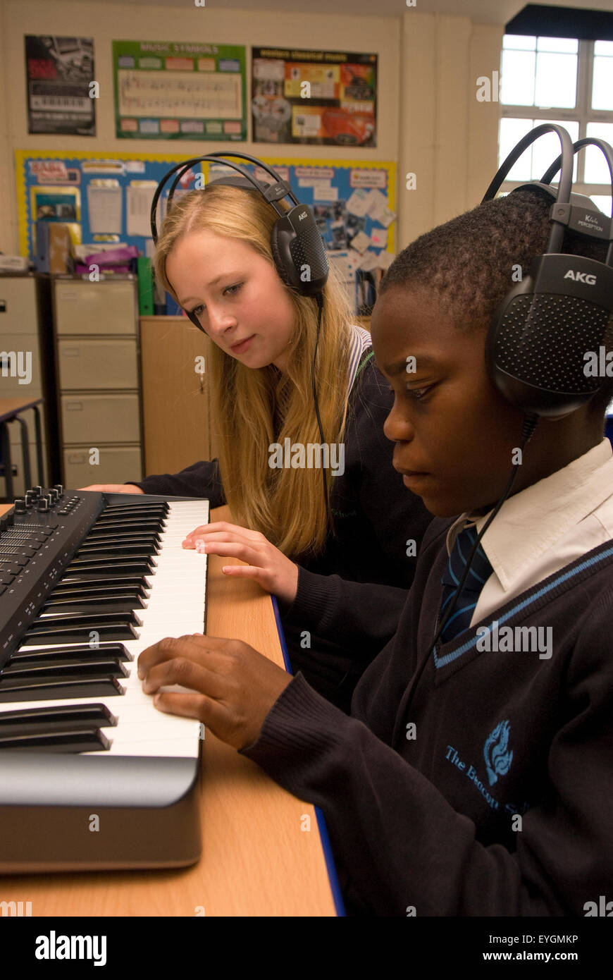 Secondary school pupils learning the keyboard in classroom, Surrey, UK