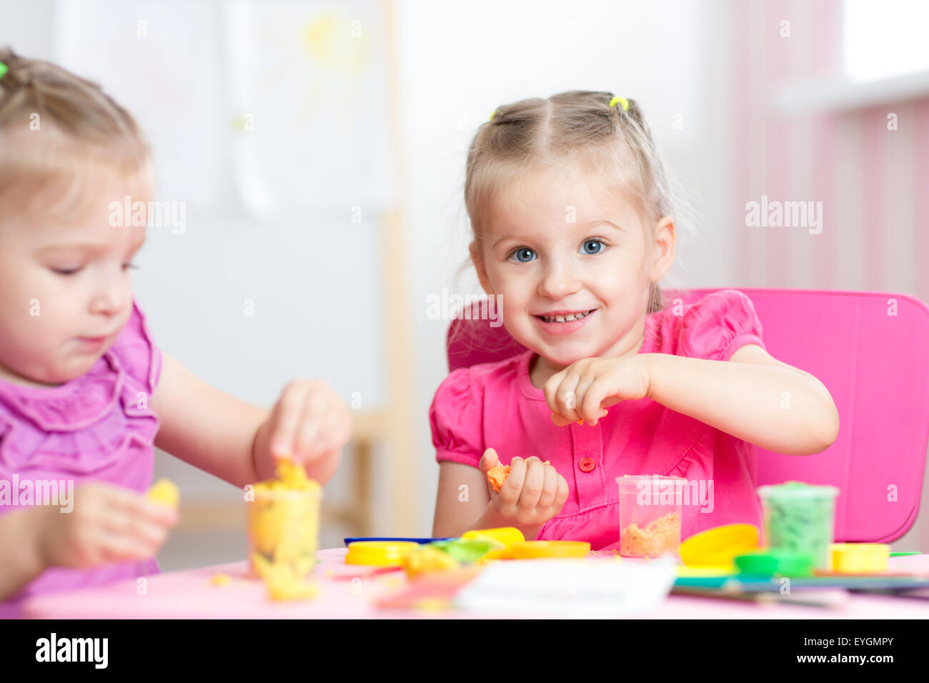 children playing with colorful clay Stock Photo
