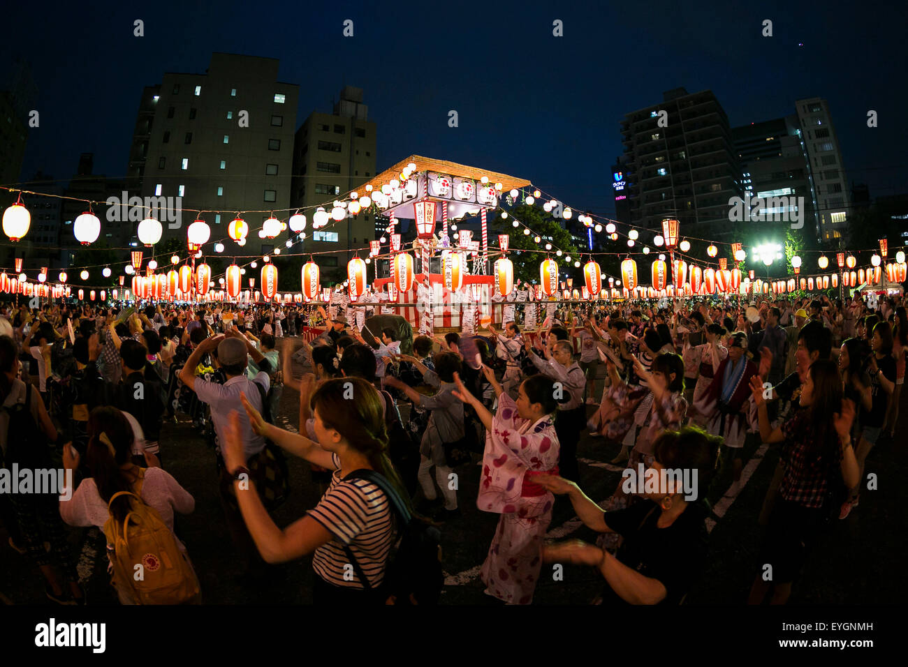 People dance in a circle to the sound of a traditional Japanese taiko drum performance at the ''Noryo-bonodori'' or Bon Dance Festival at Tsukiji Honganji Temple on July 29, 2015, Tokyo, Japan. The annual event is one of the most popular Bon Odori festivals in Tokyo, and is held from July 30 to August 2. © Rodrigo Reyes Marin/AFLO/Alamy Live News Stock Photo