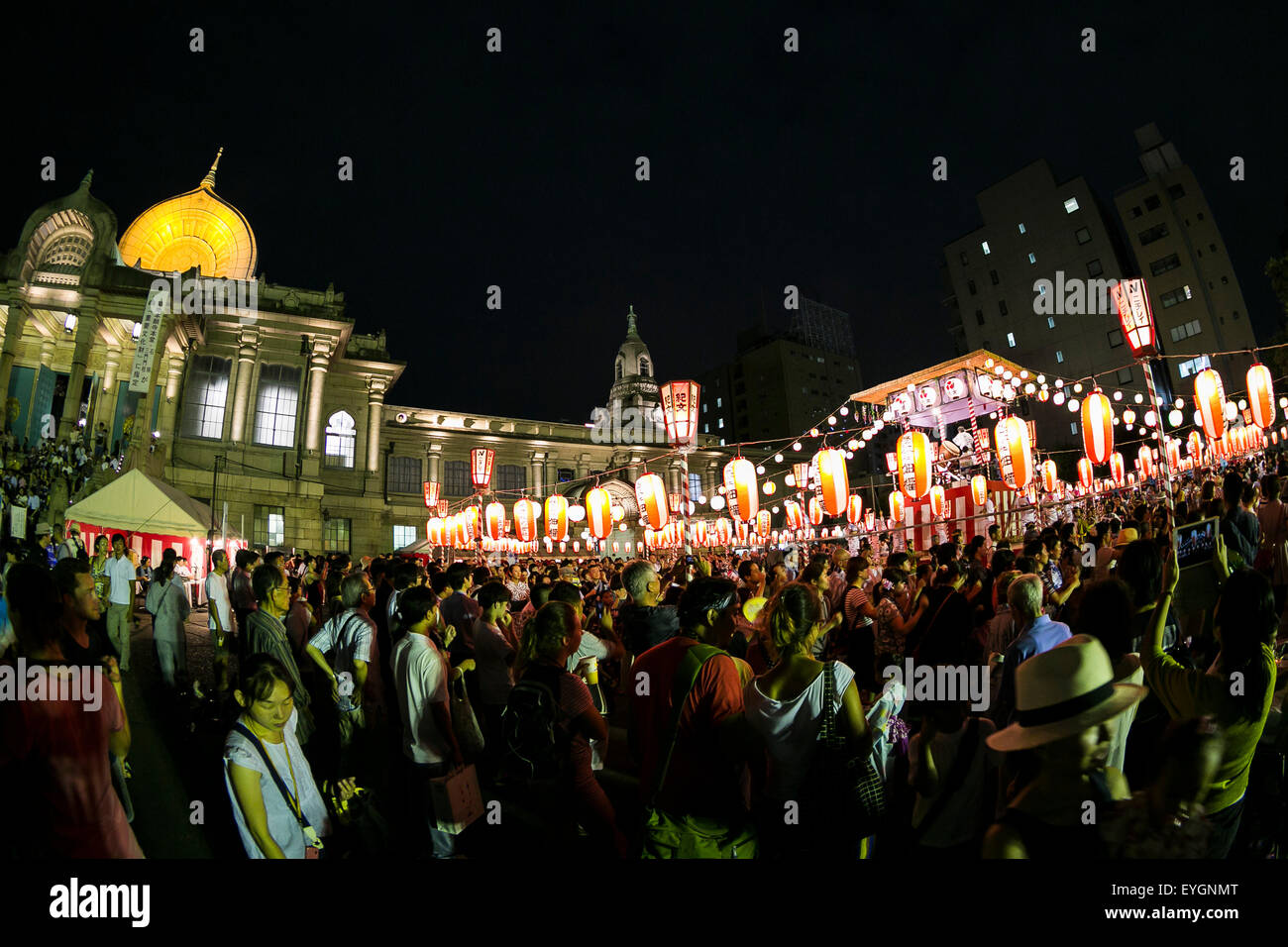 People dance in a circle to the sound of a traditional Japanese taiko drum performance at the ''Noryo-bonodori'' or Bon Dance Festival at Tsukiji Honganji Temple on July 29, 2015, Tokyo, Japan. The annual event is one of the most popular Bon Odori festivals in Tokyo, and is held from July 30 to August 2. © Rodrigo Reyes Marin/AFLO/Alamy Live News Stock Photo