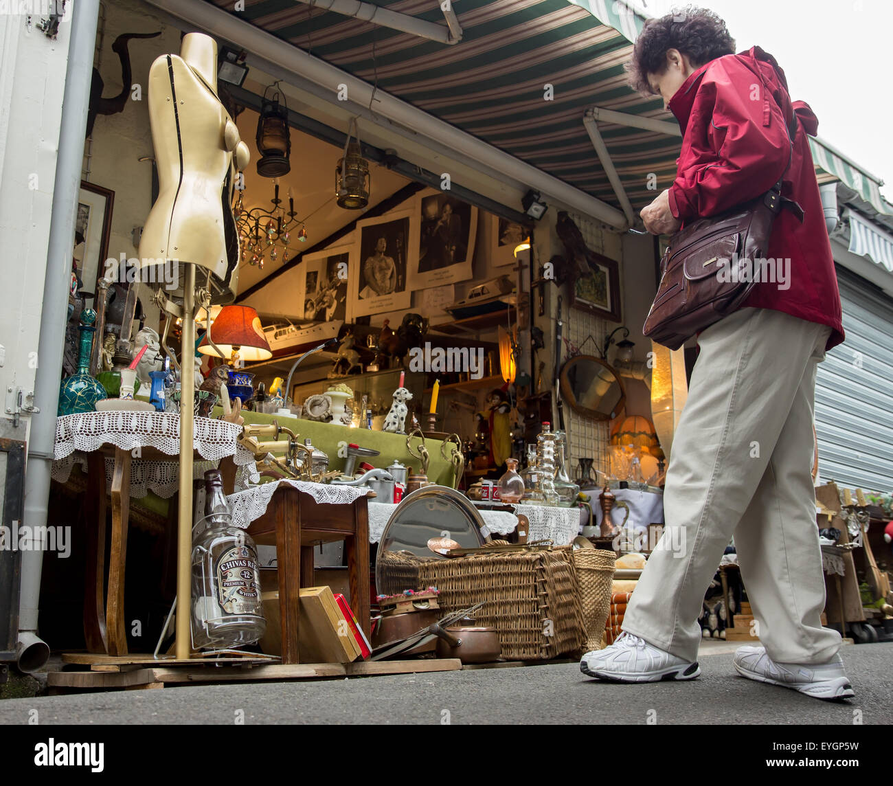 senior looking at merchandise in shop at the weekend flea market Stock Photo