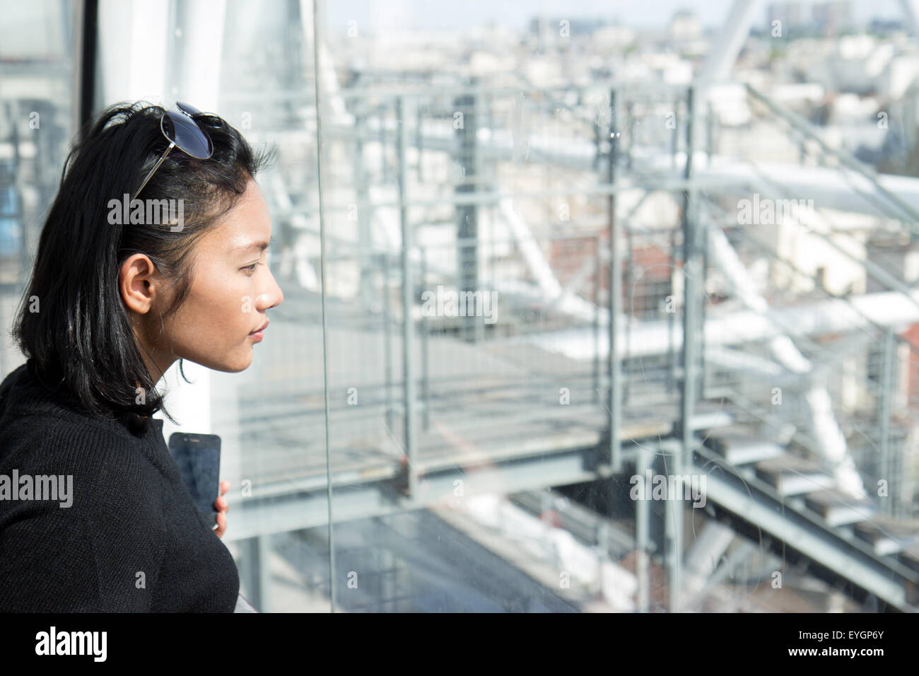 Woman on the lookout over the city of Paris Stock Photo