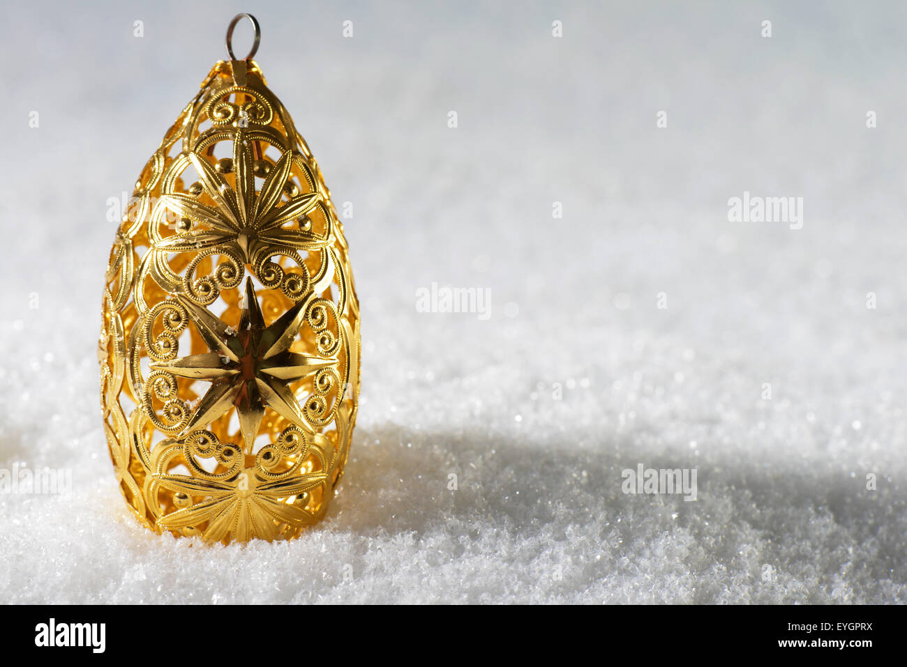 Christmas decoration in gold  on snow Stock Photo