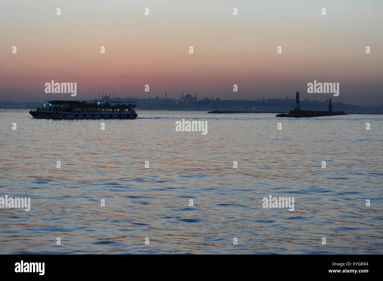 Ferry in sunset on the Bosporus viewed from Kadiköy toward Sultanahmet Blue Mosque Fähre Sonnenuntergang Blaue Moschee Stock Photo