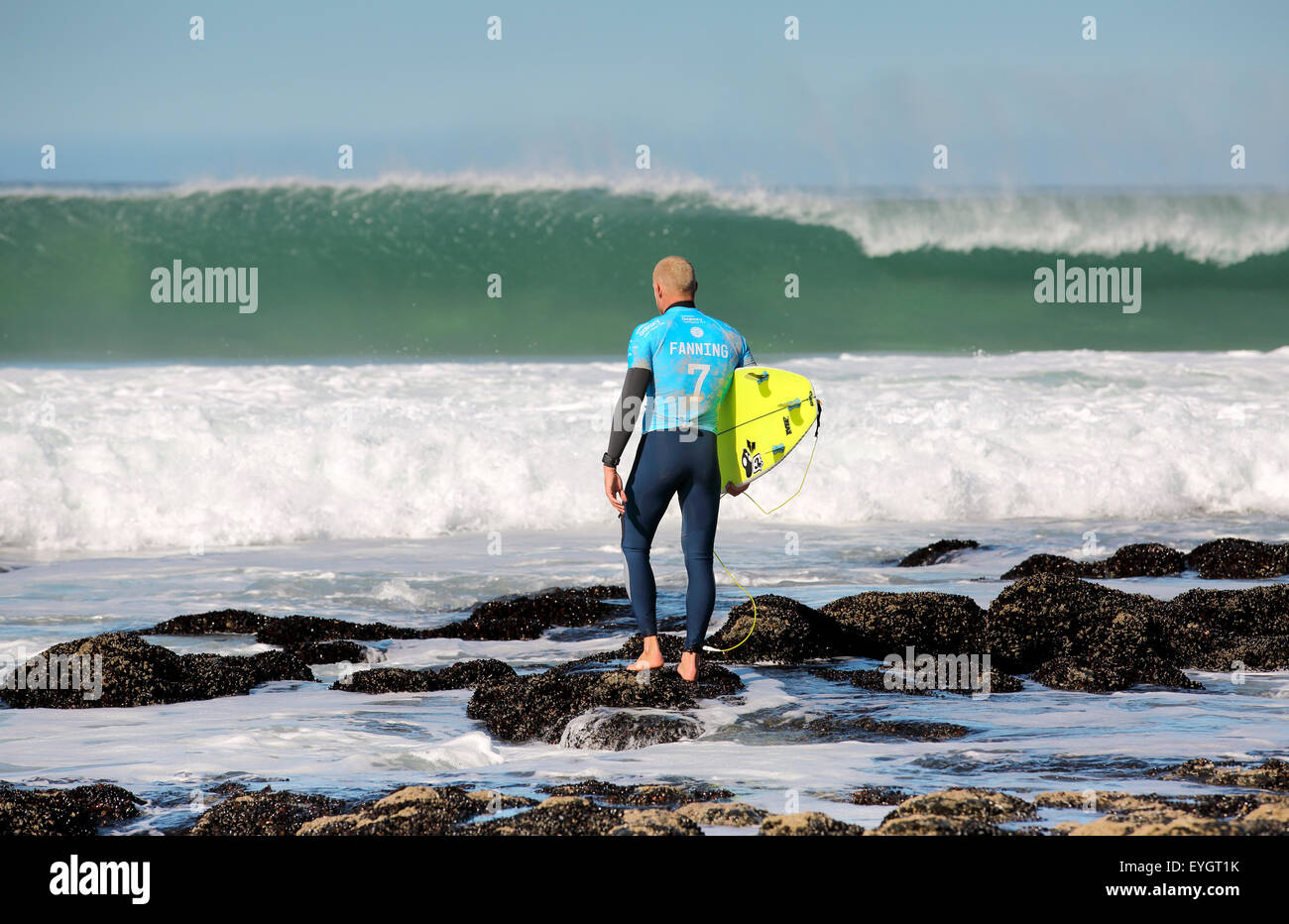Australian professional surfer Mick Fanning entering the water at the 2015 J-Bay Open surfing event in Jeffreys Bay Stock Photo
