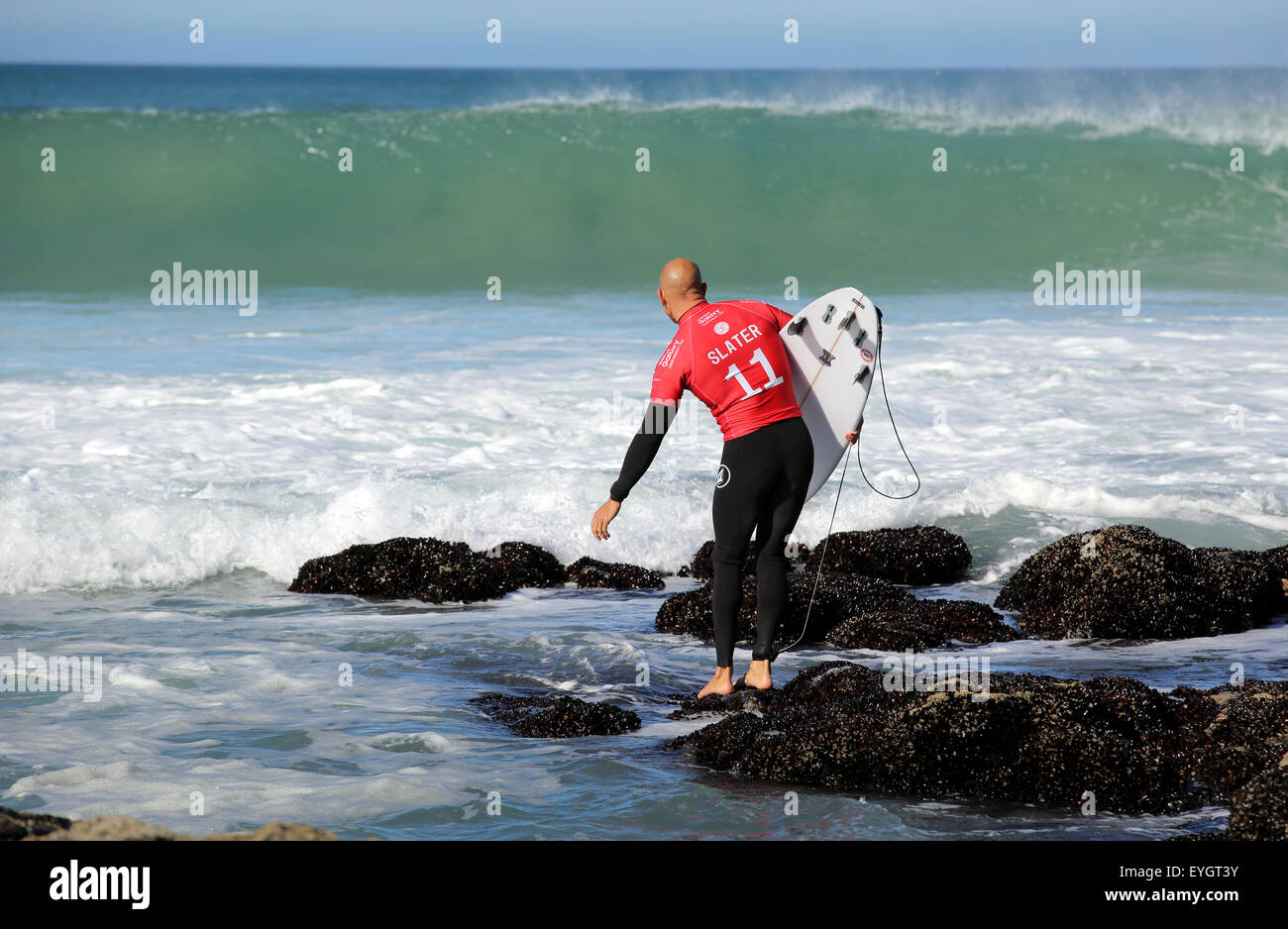American professional surfer Kelly Slater entering the water for his ...