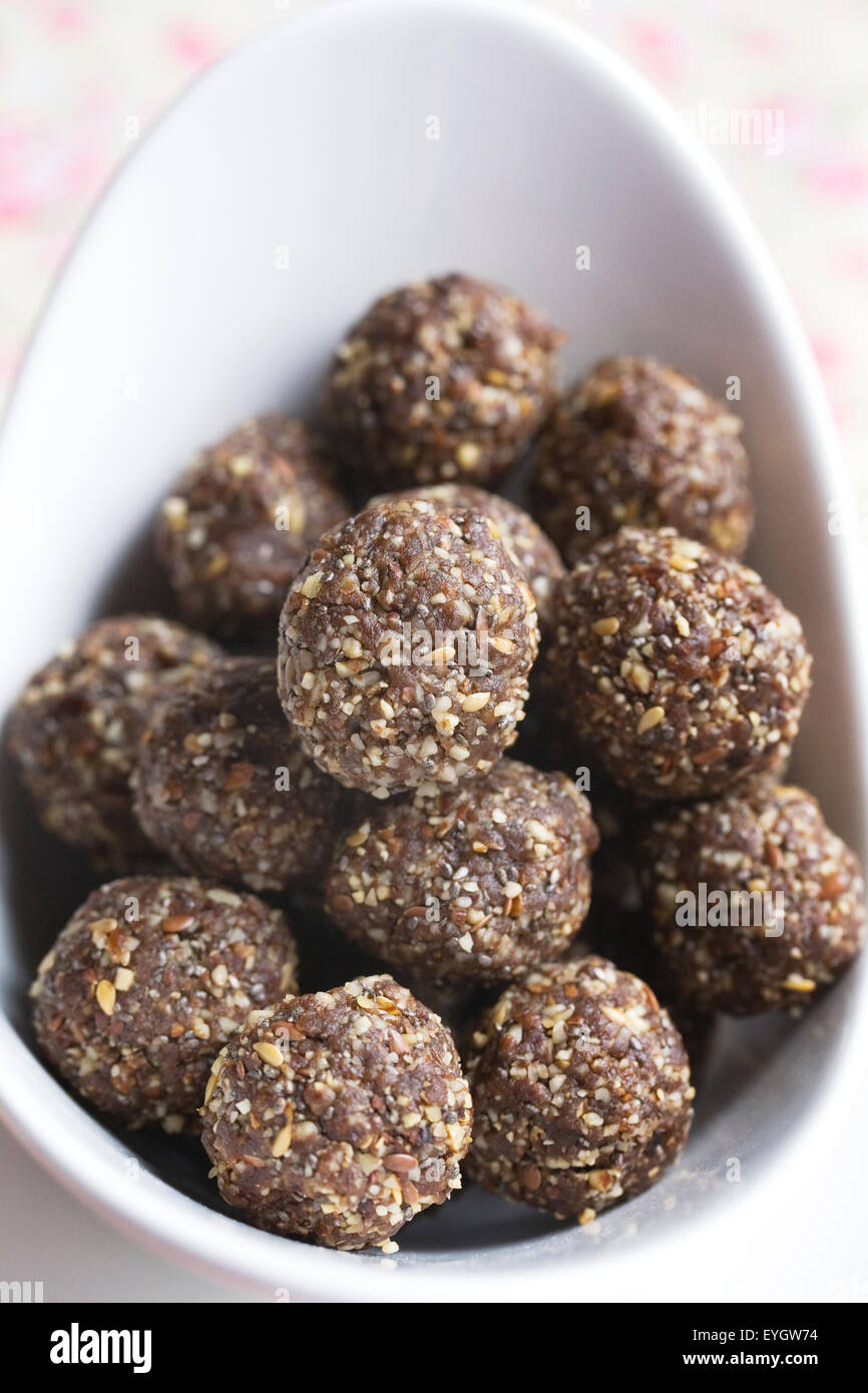 Raw food. A bowl of date, seed and nut bites. Stock Photo