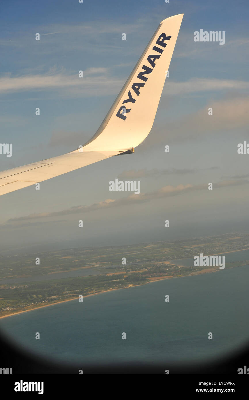 A Ryan Air wingtip viewed through the window of a Ryan Air flight fro Gatwick to Dublin. Stock Photo