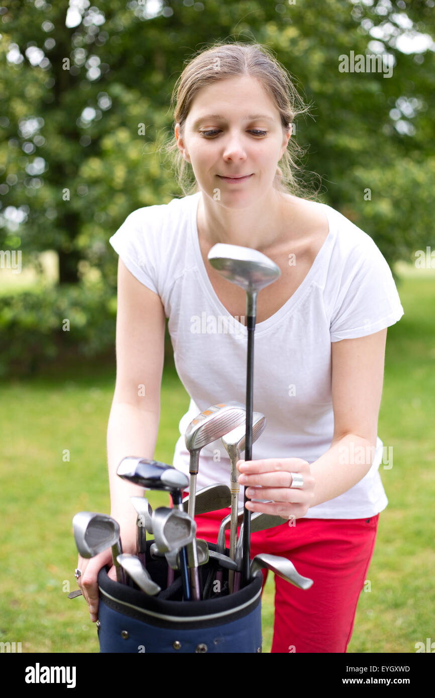 young woman picking her golf club Stock Photo