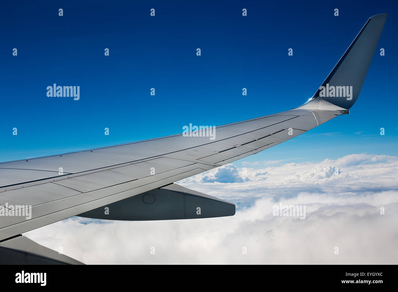 Airplane wing on sky and clouds background Stock Photo